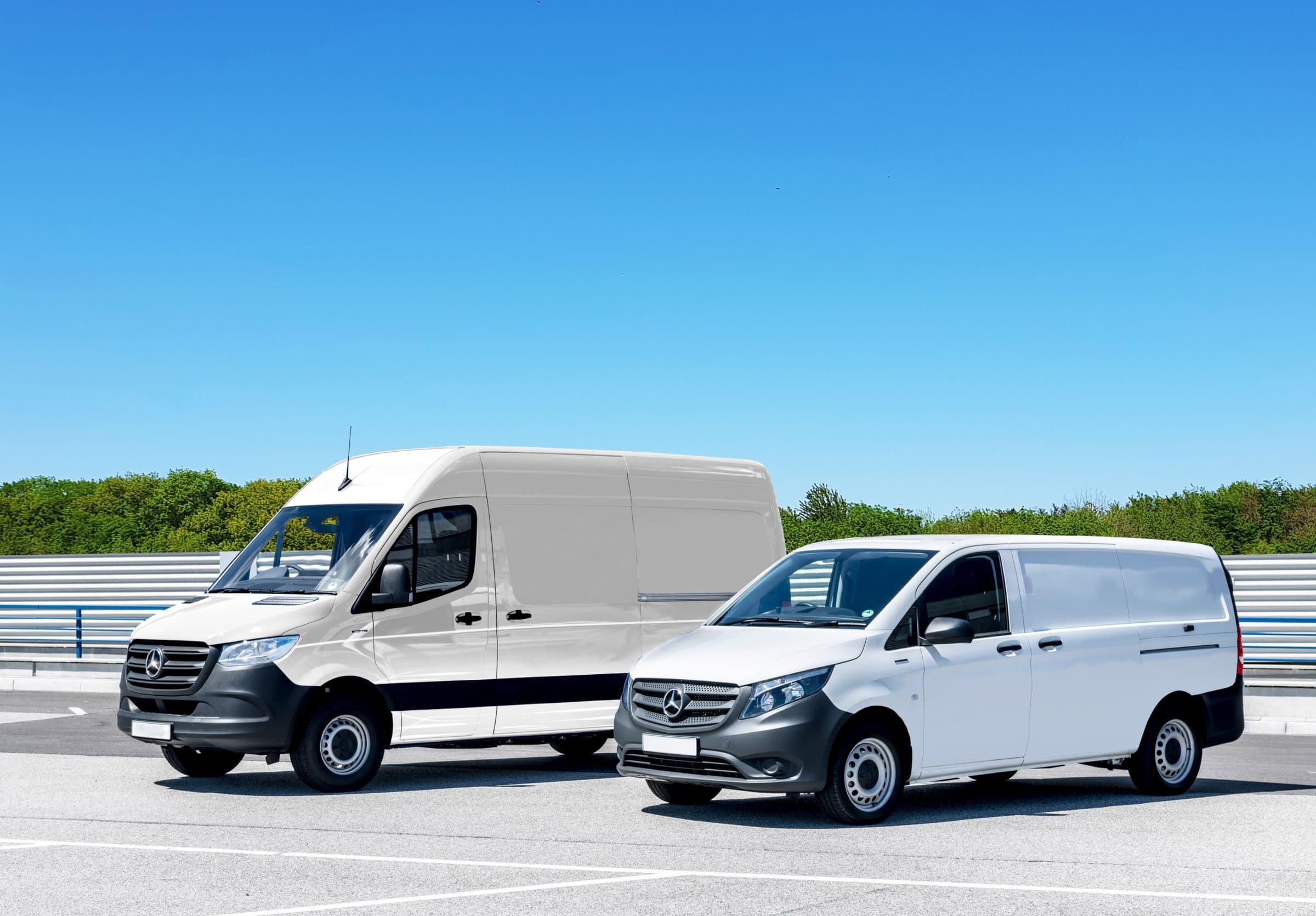 Two white work vans in a parking lot, business vehicles a commercial auto policy covers