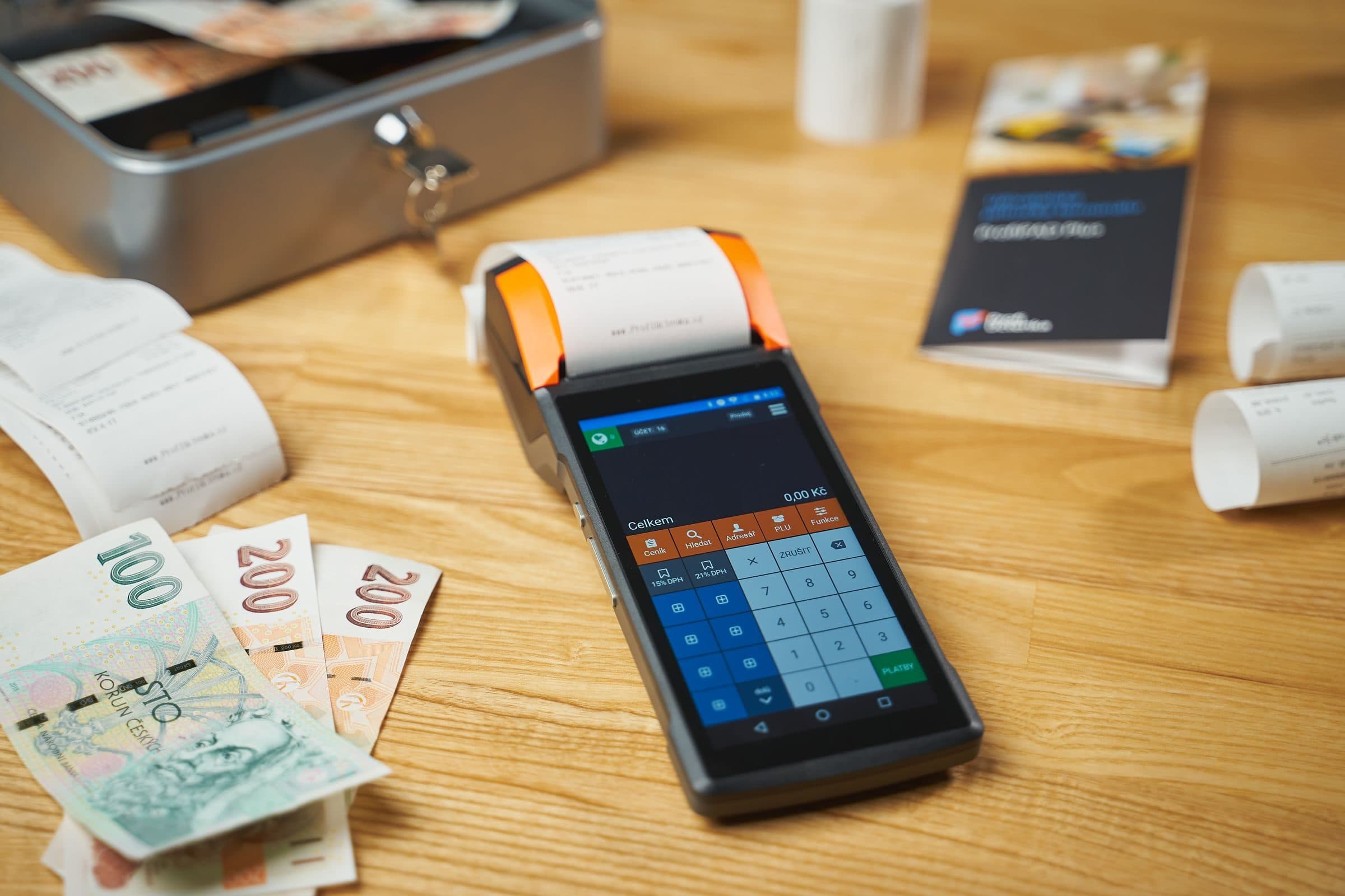 A card terminal, cash and receipts on a shop counter, money that commercial crime insurance protects from theft and employee dishonesty