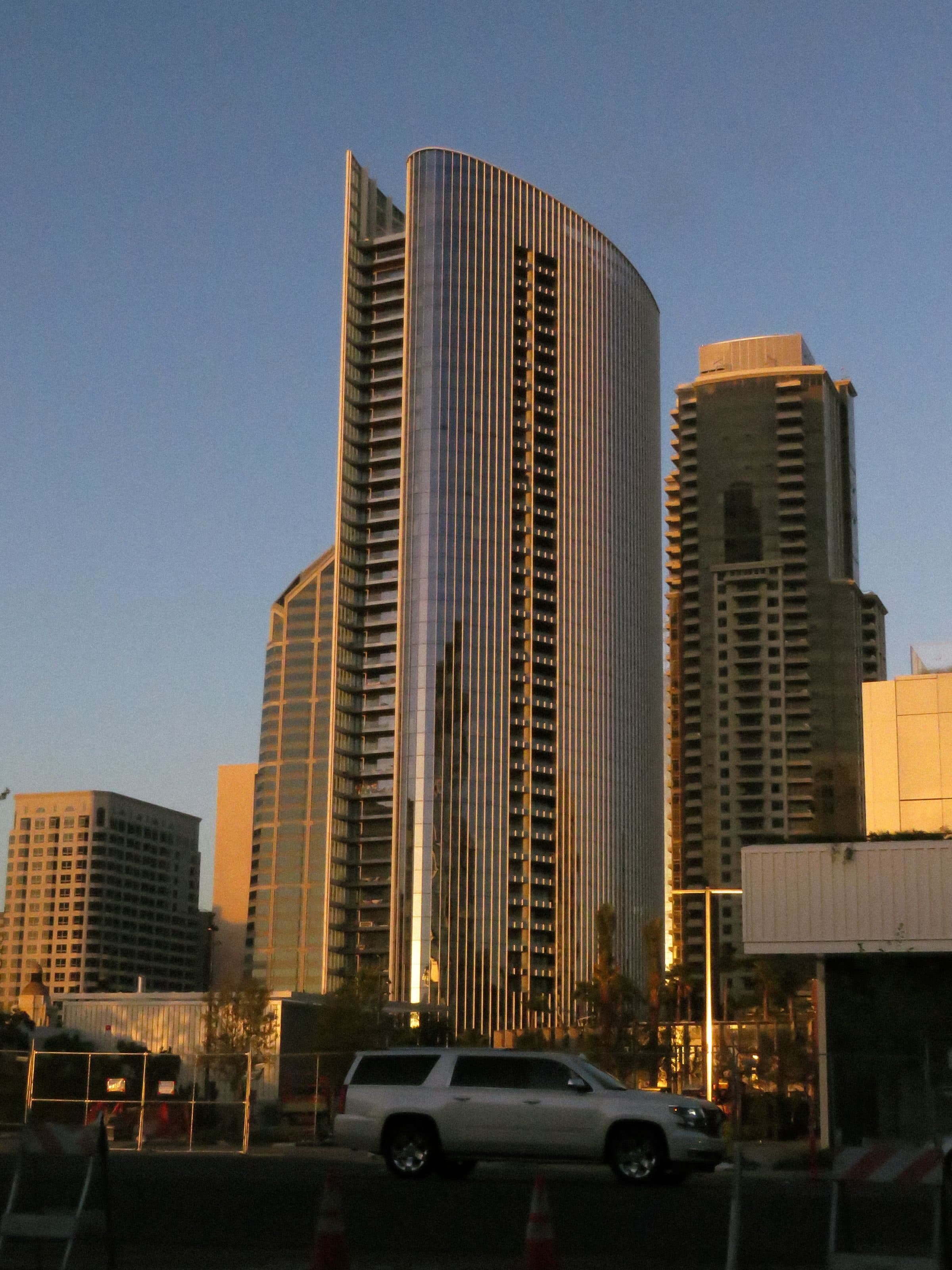 High-rise towers in a city center at dusk, where large liability claims call for umbrella limits above the primary policies