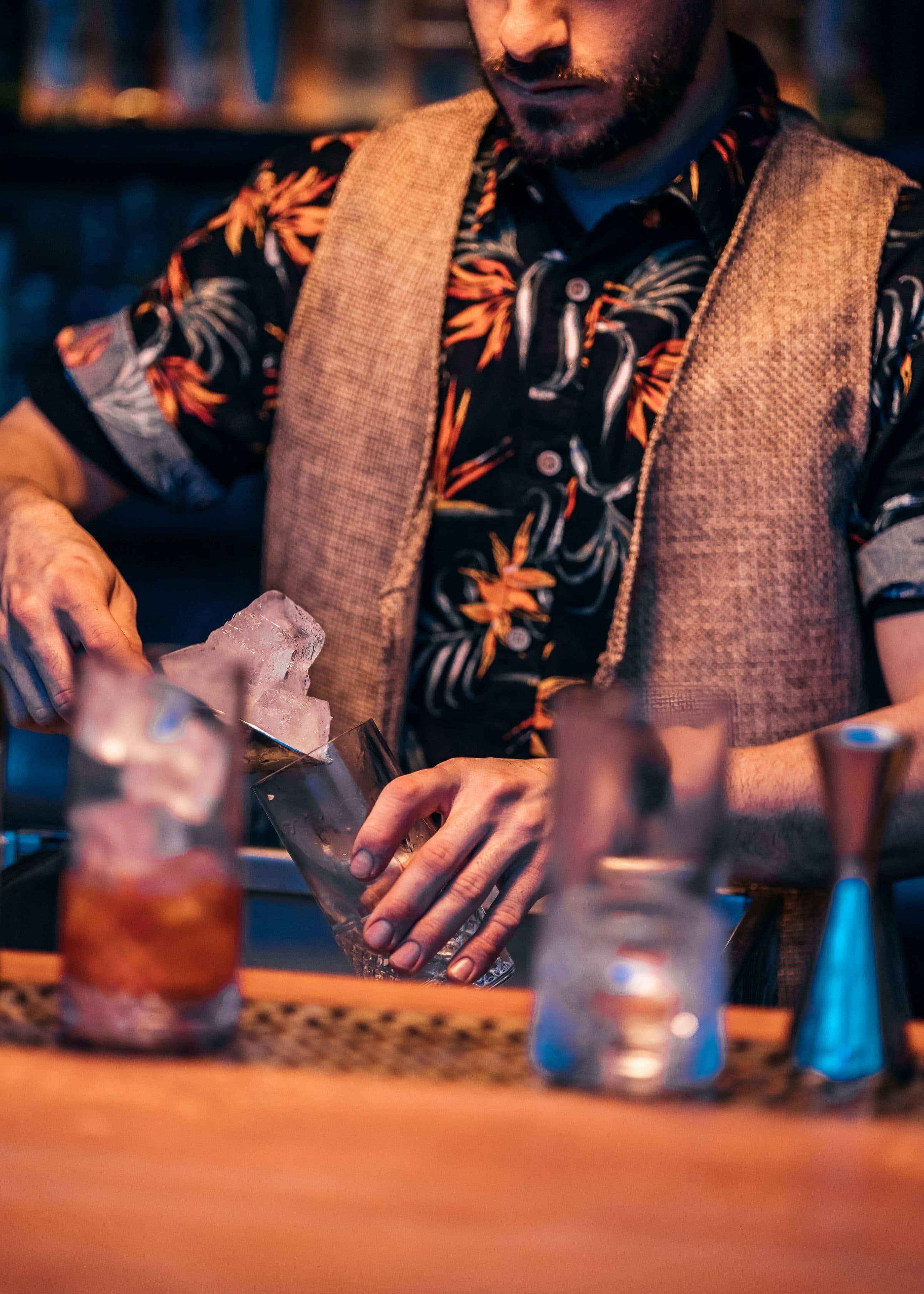 A bartender preparing drinks at an event bar, alcohol service a special event policy has to account for