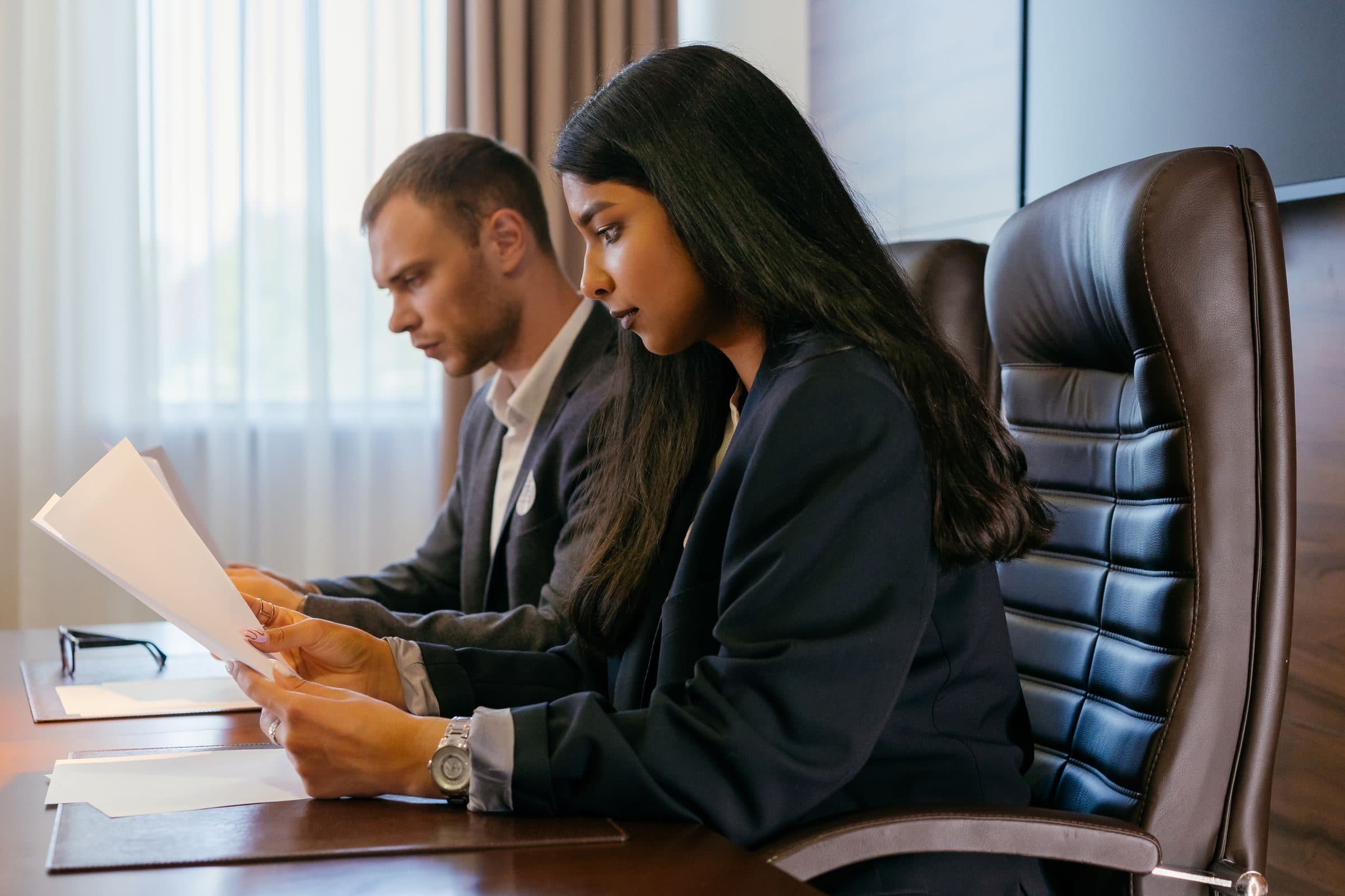 Business professionals reviewing printed documents together