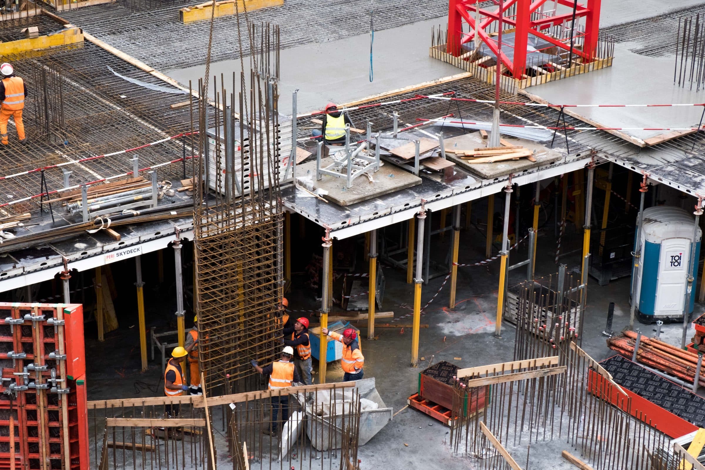A crew pouring concrete floors on a building site, workers whose job injuries workers' compensation covers