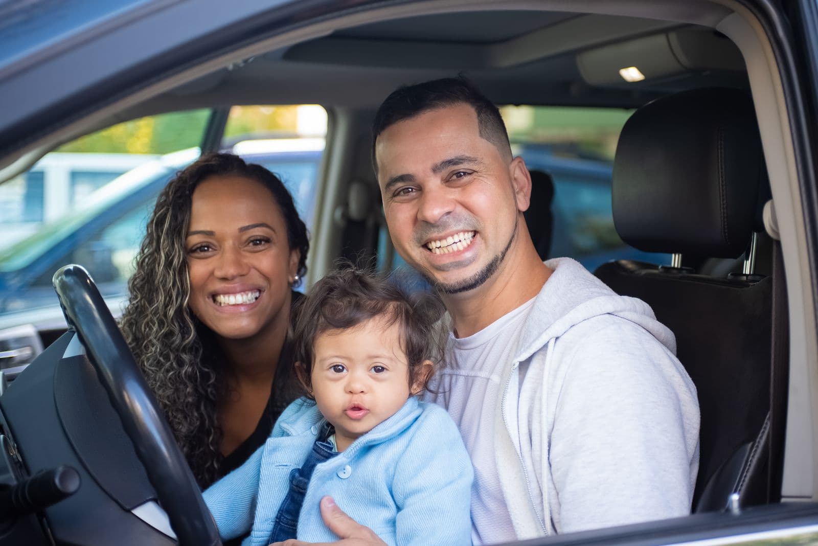 Parents and their child inside a car