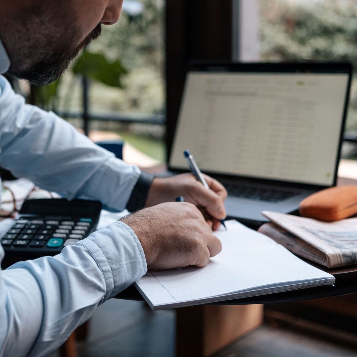 A business owner working through figures with a calculator