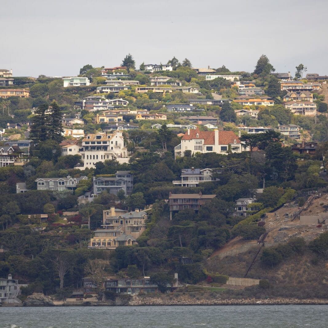 Homes on a steep California hillside by the bay, houses that need earthquake cover beside a FAIR Plan policy