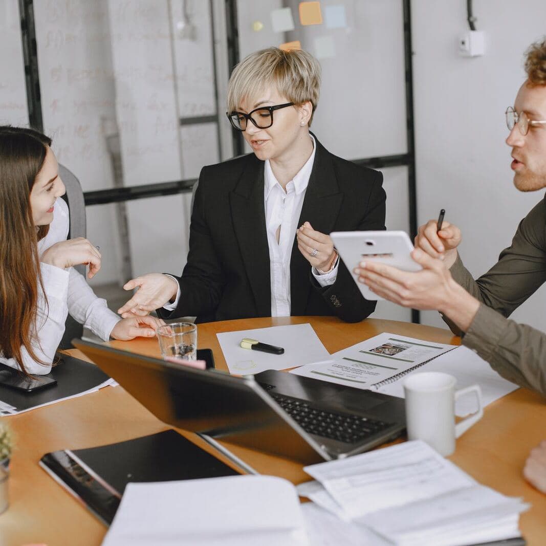 Executives working through papers in a meeting room