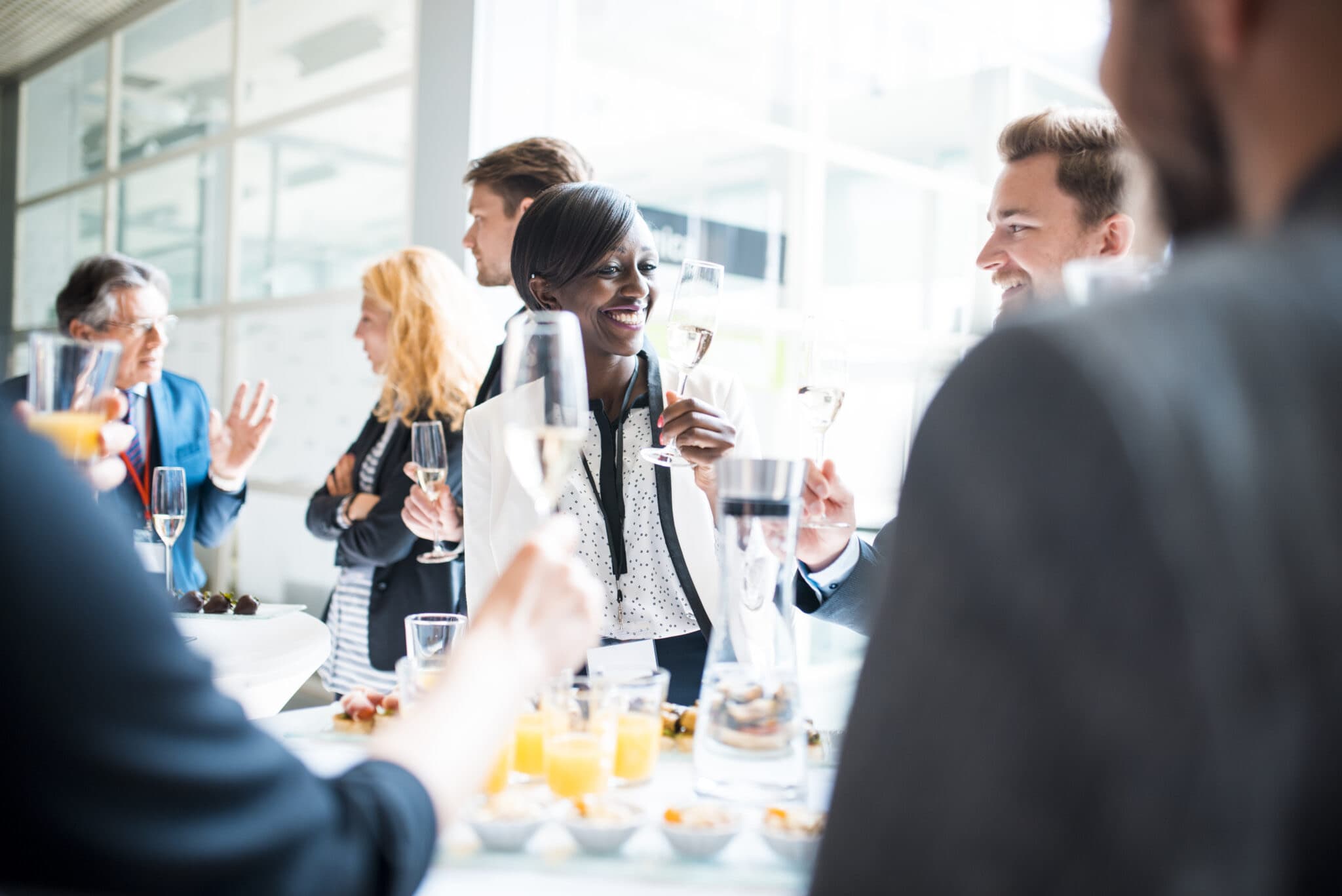 Guests raising champagne glasses at a catered daytime reception, an event covered by special event liability